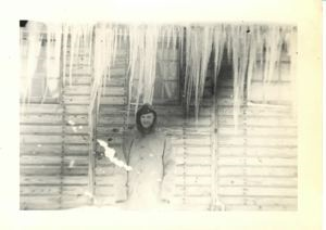 Image of Officer by barracks. Big icicles