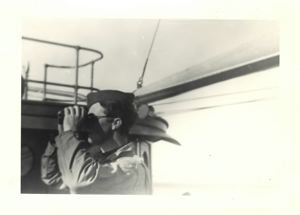 Image: Officer aboard, using binoculars