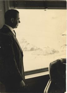 Image of Rutledge standing looking out window, possibly at Cliff House