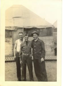 Image of Rutledge in fatigues, with two men