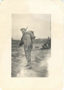 Image of Rutledge with rifle and gear