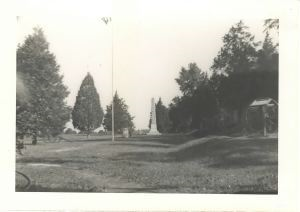 Image of Flag pole and obelisk in a park