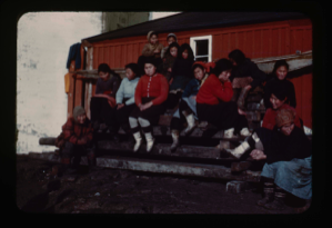 Image of Inuit group by wooden house