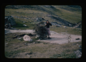 Image of Greenlandic woman carrying driftwood