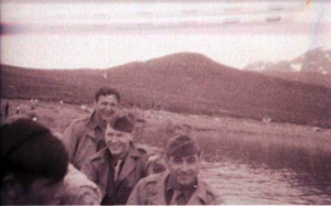 Image: Three men in uniform standiing iin foreground