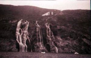 Image of Three small waterfalls, small ice floes at their base
