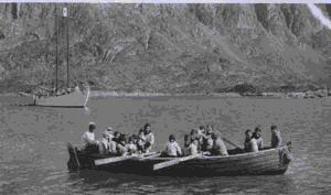 Image of Eskimo [Inuit] visitors arriving in large boat