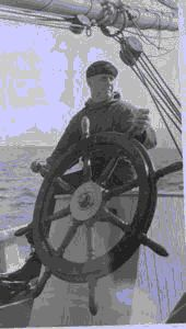 Image of Capt. Mac at wheel of the BOWDOIN