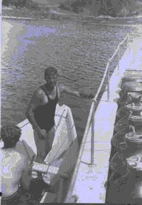 Image: Two crewmen in dory by BOWDOIN. One wears swim suit