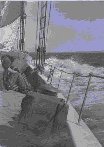 Image of Crewmen sitting on deck - starboard list