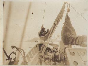 Image of Crewman resting in hammock above deck