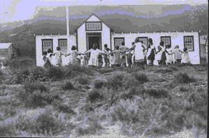 Image of School children playing a circle game in schol yard
