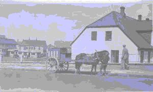 Image of Horse and two-wheeled wagon in downtown Reykjavik