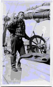 Image of Jack Crowell at wheel of schooner
