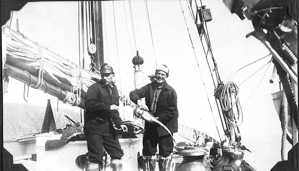 Image of Arthur Ruecket, and Alfred Weed holding large fish - aboard