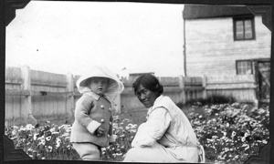 Image of Martha and Tomlinson child in poppy garden of Moravian Mission
