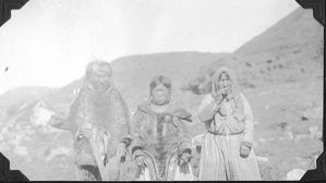 Image of Eskimo [Inuit] man and two women at mouth of Sylvia Grinnel River