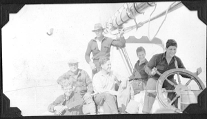 Image of Six crewmen by wheel
