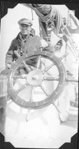 Image of Crewman and Eskimo [Inuk] man by wheel