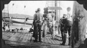 Image of Crewman on dock with movie equipment