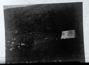 Image of Tent against rocky bluff  