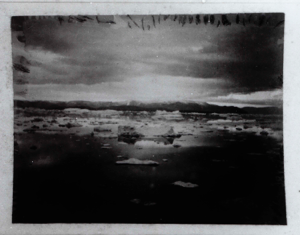 Image: Ice floes, distant mountains, clouds  