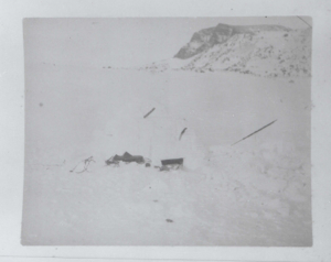 Image: Equipment on snow. Bluff beyond  