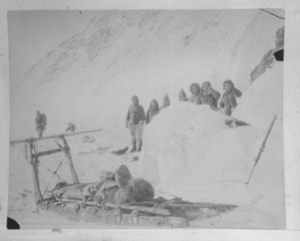 Image: Sledge with partial load; seven Inuit by igloo [iglu]  