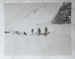 Image of Team resting; three men by sledge - with odometer  (N-7)