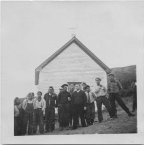 Image of Group of Innu in front of church at the encampment [Father J. Cyr, Joe Rich and others]