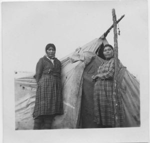 Image of Two Innu women by tent [ Muskamin (Alice) Benuen (l) and Matenin Katshinak]