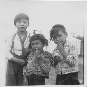 Image of Three Indian [Innu] children eating candy