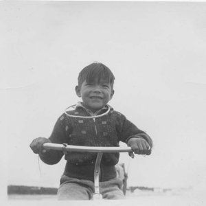 Image of Indian [Innu] boy on tricycle
