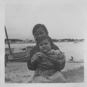 Image of Indian [Innu] boy holding younger sister