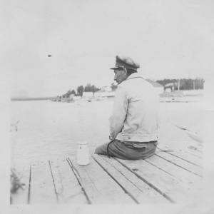 Image of A native [Innu] on the dock looking toward Little Lake