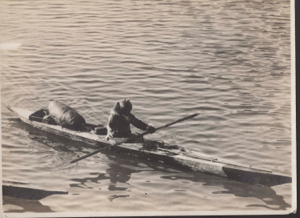 Image of Inuit in kayak, with seal float