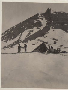 Image of Sipsoo's tupic at Ig-lu-nark-suan Point [Inuit families by tupik; woman on sledge]