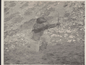 Image of Ka-ko-chee-ah with bow and arrow in shooting position