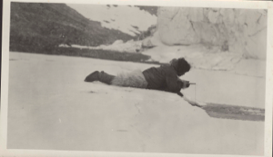 Image: Inuit lying on ice, jigging for fish