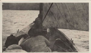 Image of Inuit and a kayak in a boat. Sail up