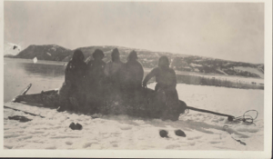 Image: Eskimos [Inuit] sitting on dead narwhal near Cape Sabine
