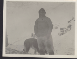 Image of Oo-bloo-ya II [Inuit man with dogs by sledge. Crates beyond]