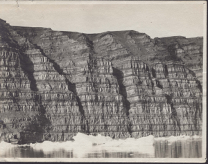 Image: Striated cliff formation, ice in foregropund