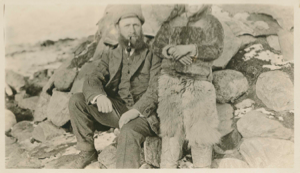 Image: Fitzhugh Green or Harrison Hunt sitting by Inuit (face out of photo frame) 