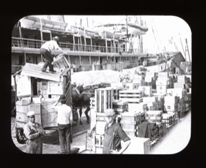 Image of Pier; loading supplies. Horse-drawn cart