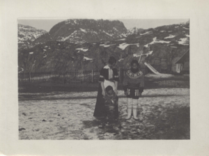Image of White woman and child, West Greenlandic woman near picket fence