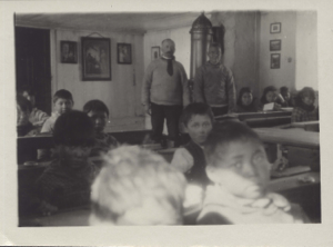 Image: Two men,  and children in schoolroom
