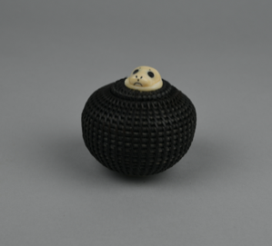 Image of small baleen basket with tiny lid, large-eyed seal finial