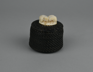 Image: baleen basket with finial carved into two walruses with tusks