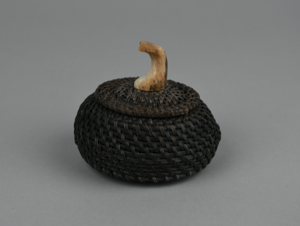 Image: baleen basket with fossil ivory finial carved into whale flukes
